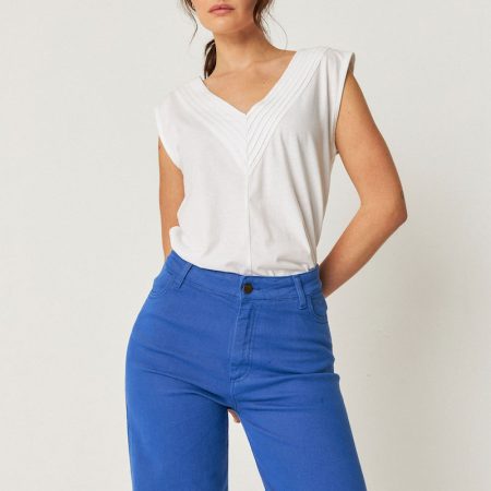 Camiseta ZUNTZ-1 de SKFK en color blanco, sin mangas y con cuello de pico plisado, fabricada con materiales orgánicos.